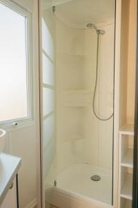 a bathroom with a shower and a toilet at Camping intercommunal de Beaurepaire in Beaurepaire
