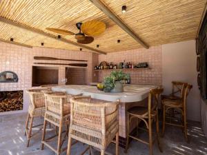 a kitchen with a large table and chairs at Yellowtail Finca in Plettenberg Bay