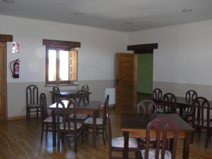 a dining room with wooden tables and chairs at La Candela in Rabanal del Camino