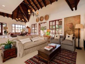a living room with a couch and a table at Yellowtail Finca in Plettenberg Bay +75 photos