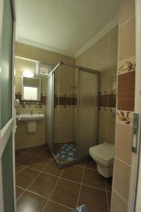 a bathroom with a shower and a toilet and a sink at Taner Otel in Oludeniz