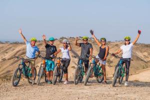a group of people on bikes on a dirt road at SEVEN SAINTS Lodges in El Karia