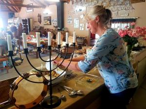 a woman standing at a counter with aorah with candles at Eingedi Retreat in Kommissiepoort +21 photos