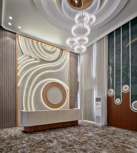 a rendering of a lobby with a chandelier at Pride Elite Gandhinagar in Gandhinagar
