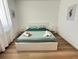 a bedroom with a bed with two stuffed animals on it at La Petite Escapade-Free Parking in Liège