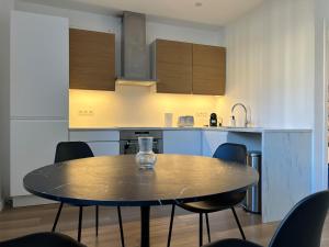 a table and chairs in a kitchen with a table and a counter at La Petite Escapade-Free Parking in Liège