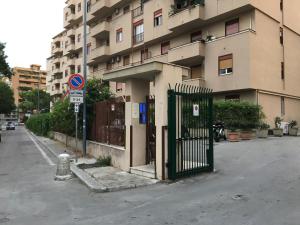 a building with a gate on the side of a street at Room61 in Palermo
