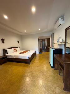 a bedroom with a bed and a desk in it at Lanta White Rock Resort in Ko Lanta