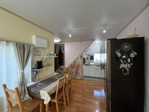 a kitchen and dining room with a table and chairs at Guesthouse&Café Deep in Kōzushima +47 photos