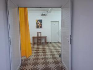 an open door to a room with a table at Bee Rooms Nosy be in Ambatoloaka +9 photos