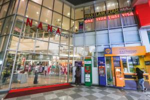 a shopping mall with people standing in front of a store at Hom Hostel & Cooking Club in Bangkok