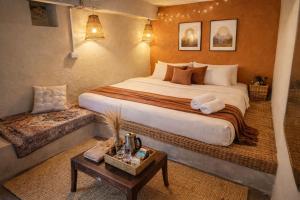 a hotel room with a large bed and a table at The Gypsy Soul Mukteshwar in Mukteshwar