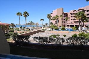a view of a resort with palm trees and the ocean at Pinacate Marina Resort - Villa 11 in Puerto Peñasco