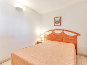 a bedroom with a wooden bed in a room at Alizea Beach A N106 2P4 in Valras-Plage