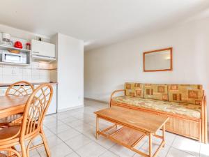 a living room with a couch and a table at Alizea Beach A N106 2P4 in Valras-Plage +4 photos