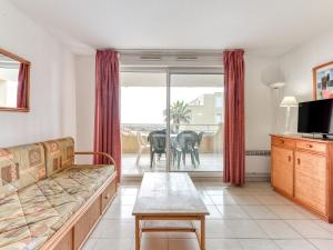 a living room with a couch and a table at Alizea Beach A N106 2P4 in Valras-Plage