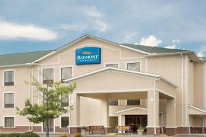 a hotel with a sign on the front of a building at Baymont by Wyndham Augusta Riverwatch in Augusta