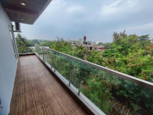 a balcony of a house with a view of trees at RT RESIDENCY HOTEL and LODGE in Nandurbār