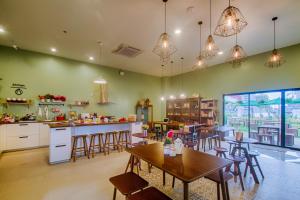 a kitchen and dining room with a table and chairs at Hom Hostel & Cooking Club in Bangkok