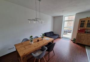 a living room with a wooden table and chairs at Süße Marie 3 in Karlsruhe