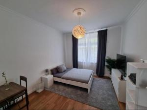 a bedroom with a bed and a table and a window at Süße Marie 3 in Karlsruhe
