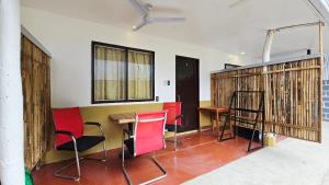 a room with chairs and a table and some windows at YOLINDA's TOURIST INN in El Nido