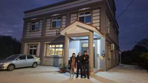 a group of people standing in front of a house at Kinmen Xinya Homestay in Jinning