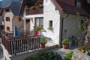 a building with a balcony with plants on it at Apartment Vito in Bovec
