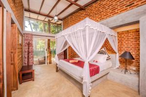 a bedroom with a bed with a canopy at Nos Da Ty Hotel in Ahangama +56 photos