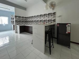 a kitchen with a counter and a fireplace at Miraana Nest in Sungai Petani
