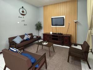 a living room with a couch and a tv at Miraana Nest in Sungai Petani