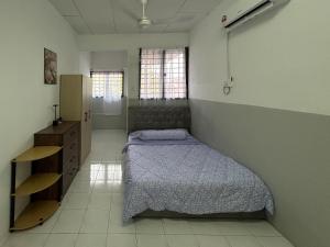 a bedroom with a bed and a dresser in it at Miraana Nest in Sungai Petani
