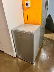 a small refrigerator sitting next to a wall at Craftsmanship Unit 235 in Johannesburg