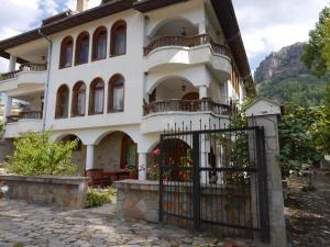 a house with a gate in front of it at Family Hotel Silver in Smolyan
