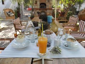 a table with food and drinks on top of it at Kyfanta, studios & apartments in Kyparissi in Kiparission