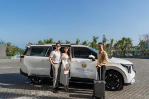a group of three people standing next to a white suv at Nesta Celia Danang Hotel in Danang