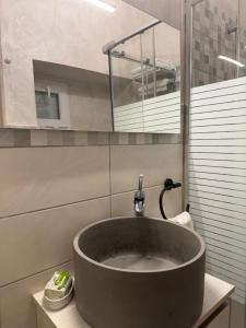 a bathroom with a large sink and a mirror at Dimora Lanamar in Conversano