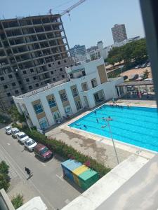 an overhead view of a swimming pool in a building at Cozy 2 BR with 3 Beds, AC & Hot Shower at Buxton Point Apartments Off RG Road Gate A in Mombasa +8 photos
