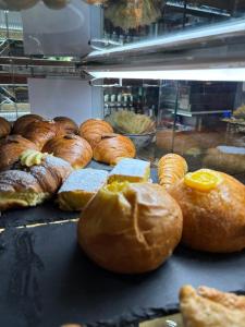 a bunch of different types of bread and pastries at Il Viale in Imola