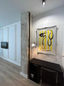 a room with a wall with a painting on the wall at La Baltasara Apartments in Valladolid