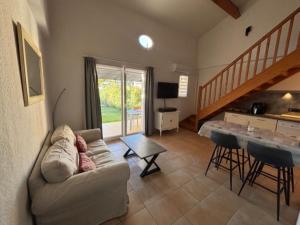 un soggiorno con un divano e un tavolo di P Minervois G N02 Villa 3P4 a Homps