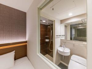 a bathroom with a toilet and a sink at Nishitetsu Hotel Croom Hakata in Fukuoka +107 photos
