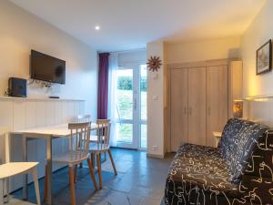 a living room with a couch and a table at Sud Ocean J N74 2P4 in Guidel