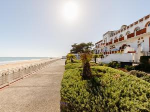 a building on the beach next to the ocean at L Ocean N40 2P5 in La Tranche-sur-Mer