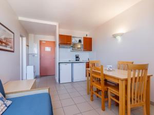 a kitchen and dining room with a table and chairs at L Ocean N40 2P5 in La Tranche-sur-Mer