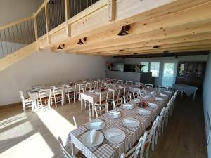 a dining room with tables and chairs and wooden ceilings at Agriturismo Taglio del Re in Jesolo