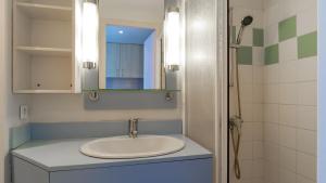 a bathroom with a sink and a mirror at Sud Ocean L N94 2P4 in Guidel +9 photos