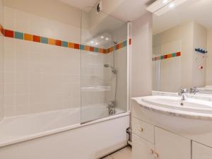 a white bathroom with a sink and a shower at L Ocean N08 3P5 in La Tranche-sur-Mer