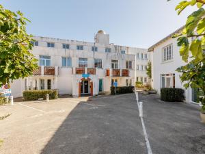 an empty parking lot in front of a building at L Ocean N08 3P5 in La Tranche-sur-Mer