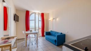 a living room with a blue couch and a table at L Ocean N36 2P2 in La Tranche-sur-Mer +6 photos